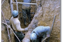 An example of a photo showing unsafe work practices on the eLCOSH site. The trench is partially unsupported, some of the shoring is not braced by screw jacks and there is a loose board above the workers’ heads.