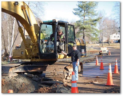 Dwayne Bell supervises a pipe project in a residential area.