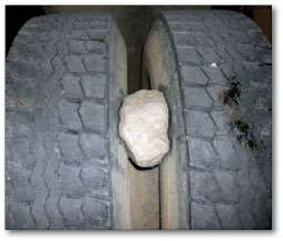 Careful and frequent inspections of mixed service tires will prevent unseen hazards like this rock from destroying a still-serviceable tire or damaging the casing so much it can’t be retreaded.