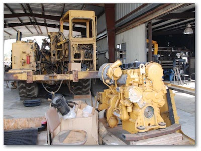 Although Don MacIntosh repowered two machines, including this Cat 623B scraper awaiting the installation of the engine at front, “the bulk of our equipment is in the 100- to 200-horsepower range, where there are not a lot of repower solutions,” he says.