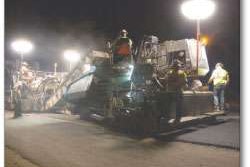 Balloon lights, like these attached to pieces along the paving train, are earning thumbs-up responses for their ability to brighten jobsites at night without the glare associated with harsher lighting sources. This Vogele Super 1800-2 tracked paver is working on Highway 99 near Fresno, California.