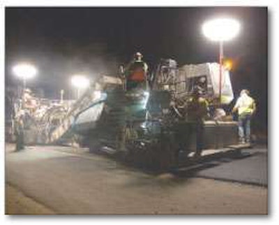 Balloon lights, like these attached to pieces along the paving train, are earning thumbs-up responses for their ability to brighten jobsites at night without the glare associated with harsher lighting sources. This Vogele Super 1800-2 tracked paver is working on Highway 99 near Fresno, California.