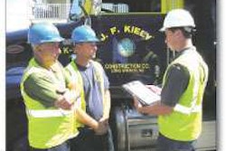 Intern Kevin Gorr conducts a toolbox talk on recognizing the signs of heat exhaustion and heatstroke with utility worker Arthur Capana, left, and foreman Jason Afanador, center, on a jobsite in Bradley Beach, New Jersey.