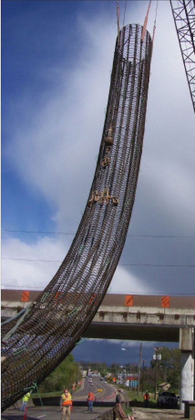 A steel rebar reinforcement cage for bent 6 will be placed into the bent to support and reinforce the structure. The orange signs visible on the bridge in the background are part of the project’s “gawker screen,” a barrier used to prevent drivers from staring at the construction site and keep focused on the road.