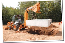 With the Power Lift option, the 15-foot-class Case 590N places this 3,500-pound concrete transfer station into the ground with ease.