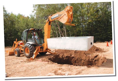 With the Power Lift option, the 15-foot-class Case 590N places this 3,500-pound concrete transfer station into the ground with ease.