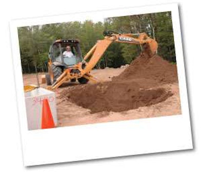 Case product promotion specialist Steve Cudd, a product demonstrator at the Tomahawk Customer Center in the Wisconsin Northwoods, digs with the strengthened back end of a new N Series backhoe loader.