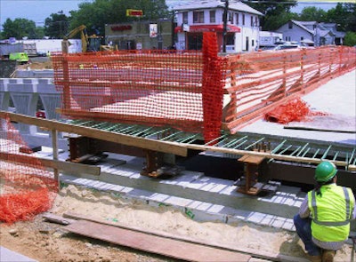 A precast panel is placed on the Eastern Ave. overpass (top) during District of Columbia DOT’s workshop on precast panels in bridge construction in July 2010.