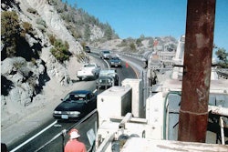 In tight quarters in the Pacific Northwest, a cold-in-place recycling train of Valentine Surfacing climbs a mountain grade.