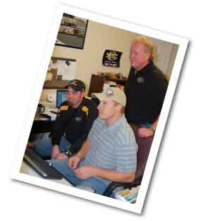 Chuck and sons Luke (left) and Frank take a long and careful look at a big bid document before hitting the send button.