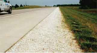 “Daylighted” permeable base – exposed here at the shoulder – is a lower-cost PCC pavement drainable design that doesn’t require separation fabric or drainage systems.