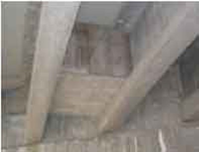 This photo was taken looking up toward the cave-type habitat on the Curtis Creek Bridge, constructed between two girders near the diaphragm on top of the supporting piles and pile cap. The bottom flange of the girders supports the floor of the bat habitat and a cutoff wall is constructed on top of this floor to create the cave. Access to inspect the pile cap and diaphragm is created on the opposite end of the cutoff wall.