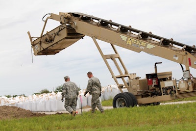 Service members from South Dakota’s National Guard use a Series 271 Screening Plant, which was engineered and manufactured at KPI-JCI in Yankton, S.D., to fill sandbags during recent flood relief efforts in the Dakota Dunes