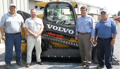 Matt Shoemaker, Chris Sauers, Russ Fairchild and Guy Fairchild of Fairchild Brothers proudly stand in front of their new Volvo MCT135C tracked skid steer loader at the Volvo Construction Equipment dealership, Highway Equipment & Supply Company, in Lock Haven, Pennsylvania.