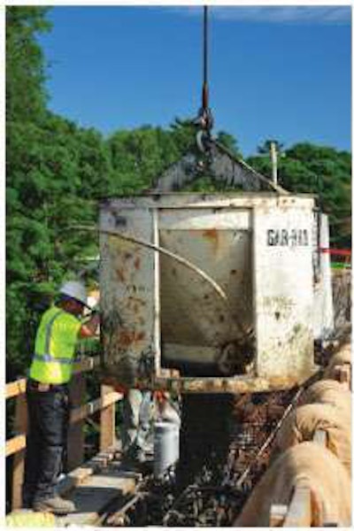 The contractor places the concrete for the tie girder, the member that holds the ends of the arch together.
