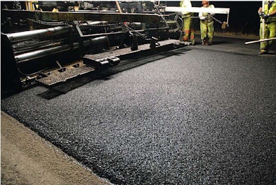 A thin crumb, rubber-modified, open-graded wearing course is placed on California Highway 1 near Fort Bragg; the mix incorporated a warm-mix additive to ensure workability, following the two-hour drive to the Pacific Coast from the plant.