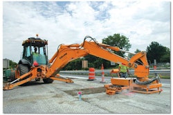 The largest backhoe loader offered by John Deere, the 710 is ideal as a carrier for a dowel pin gang drill on concrete highway patch work, says Kokosing backhoe operator Bill Roeder. Inset: Roeder, right, discusses the attachment’s performance with Minnich Manufacturing’s Mike Sansom.