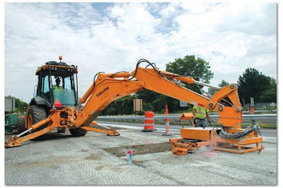 The largest backhoe loader offered by John Deere, the 710 is ideal as a carrier for a dowel pin gang drill on concrete highway patch work, says Kokosing backhoe operator Bill Roeder. Inset: Roeder, right, discusses the attachment’s performance with Minnich Manufacturing’s Mike Sansom.