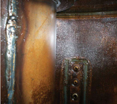 With water comes rust, here coating the top of a hydraulic tank.