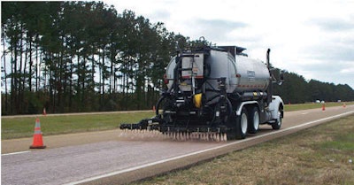 Asphalt rejuvenator is placed on U.S. 25 near Jackson, Miss., using a BearCat 2,000-gallon distributor on an abraded surface.