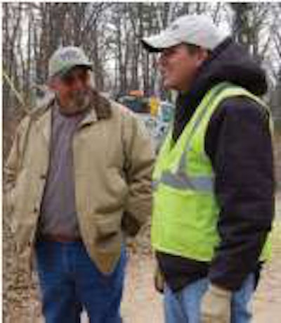 Bruce Vestal, left, a supervisor with Steelville Telephone, with John Kelly at a jobsite in the Steelville area.
