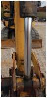CYLINDER — Look for any leaks or pitting on all cylinders. Examine seals for leaks, and check all pins and bushings for looseness.