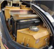 The battery should be well secured with no corrosion on the terminals.