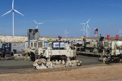 To expedite production, Koss ran two belt placers ahead of the paver (right). The first placer is partially visible (left).