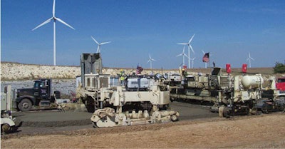 To expedite production, Koss ran two belt placers ahead of the paver (right). The first placer is partially visible (left).