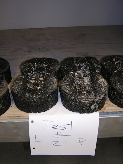 To ensure a pavement mix using recycled asphalt shingles (RAS) isn’t too soft, all mixes in Illinois must be tested with the Hamburg Wheel test. The test uses a 158-pound steel wheel, which is run under water. The specimen is put in a heated water bath and run back and forth 20,000 times
