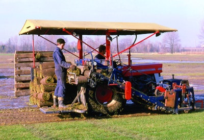 A worker uses a first production Brouwer Sod Harvester on a Massey Ferguson tractor in 1972.