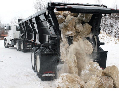 Henderson’s BlackBelt live-bottom system puts a fresh spin on the traditional end trailer. It can handle larger rock as show here, not only because the 54-inch belt is wider, but also has a 75-percent wrap on the rollers and an automatic tensioning system to match the load.