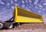 SmithCo’s side-dump design features abrasion-resistant AR400 steel for the tub, and T1 steel for the I-beam frame, which reduces weight to allow for a bigger payload.