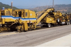 The cold-in-place recycling train features a milling machine followed by a recycler, which crushes the RAP, screens it, mixes it with emulsion and lays the material down in a windrow.