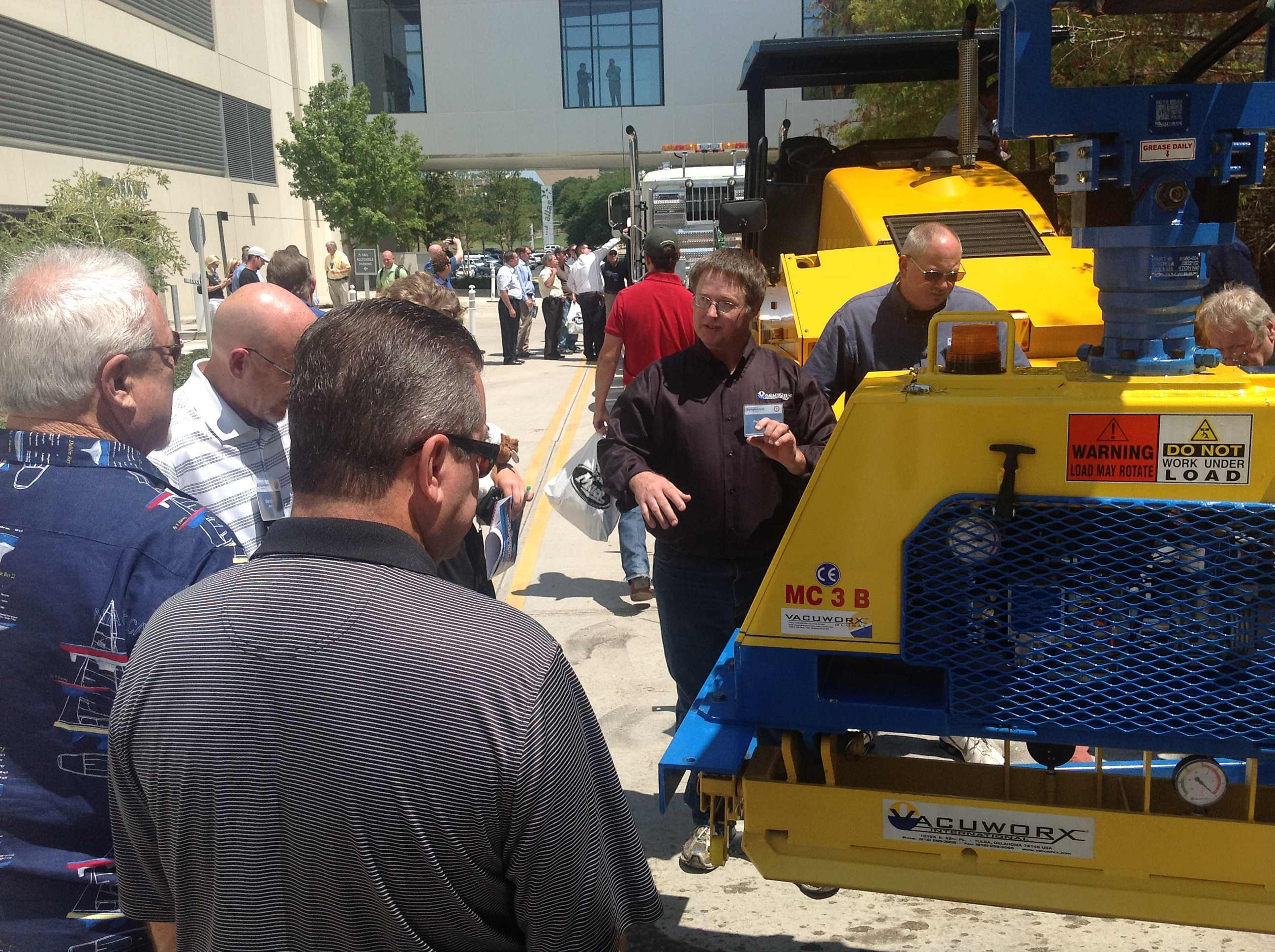 Contractors and attendees at the Construction Symposium, an industry event held in Dallas, Texas, August 21-23, check out the equipment demonstrations after a morning of presentations and learning.