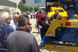 Contractors and attendees at the Construction Symposium, an industry event held in Dallas, Texas, August 21-23, check out the equipment demonstrations after a morning of presentations and learning.