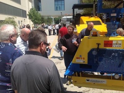 Contractors and attendees at the Construction Symposium, an industry event held in Dallas, Texas, August 21-23, check out the equipment demonstrations after a morning of presentations and learning.