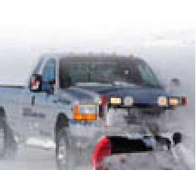 Bridgestone Winter Driving School managers follow their own advice on winter prep, equipping their pickups with dedicated snow tires for plowing miles of roads outside of Colorado Springs, Colo.