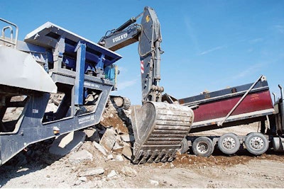 In Wisconsin, pavement demolition concrete is crushed next to a construction site. The resulting RCA will go back as base material below concrete pavement.