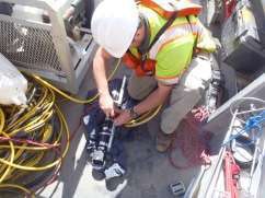 Engineer attaching sonar to pipeline