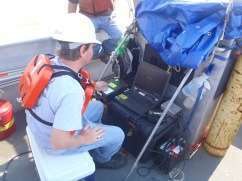 Engineer at computer station scanning with sonar system