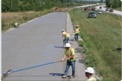 “D” Construction crews finish a freshly placed section of bonded concrete overlay on an existing asphalt pavement on Route 53 in Will County, Ill. The project used stringless paving technology on what was the old U.S. Route 66 alignment.