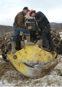 You have to be handy in this area of the country. Jon looks in on some on-the-spot skidder maintenance by operator Larry Losier, left. “My favorite day is Saturday, because I can really get my hands dirty,” says Jon.