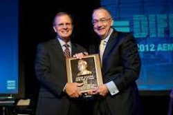 Deere & Co. Chairman and Chief Executive Officer Sam Allen accepts the AEM Hall of Fame plaque from Rusty Fowler, 2012 chair of the AEM and CEO of Krone North America