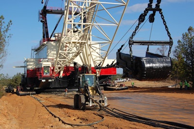 Hydraulic lines from generators mounted on three 18-wheelers are dragged forward by a tool carrier.