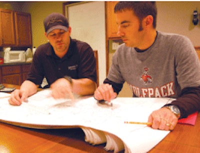 Steep and challenging engineering projects are a specialty for Bennick. Here he reviews an upcoming project with his estimator Tim Morris.