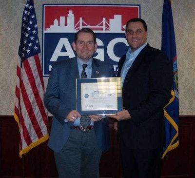 AGC New York president and CEO Michael Elmendorf, left, receives an award for military support from his employee Navy Reserve Lt. Carl Zielman. Credit: timesunion.com.