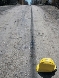 In Denver, this unpaved alley was topped with a mix of straight RAP and neat rejuvenator, and then compacted; the result is an inexpensive unpaved driving surface.