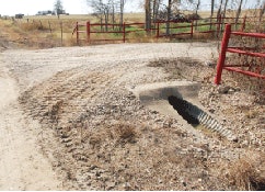 Well-built and maintained culvert keeps water off both unpaved roadways.
