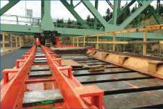 Special jacking and sliding equipment was needed to “skid” this long, heavy and old bridge sideways to temporary new piers.